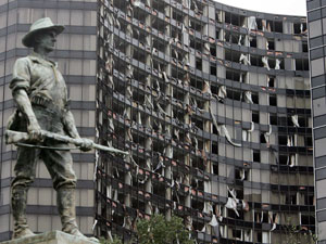 
The destroyed Hyatt Regency hotel is seen next to statue honoring Spanish-American War veterans after Hurricane Katrina hit the city (Photo by Mario Tama/Getty Images)