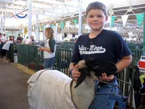 
Eleven-year-old Jacob Halferty shows off his Suffolk ewe. He says he's a bit nervous about presenting his lamb to the judges. This is Jacob's first year competeing in the Iowa State Fair.  (Nikki Tundel)