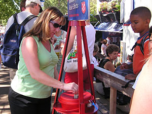 
Minnesota State Fair attendees stuff money in a Salvation Army kettle set up to assist victims of Hurricane Katrina. (MPR Photo/Laura McCallum)