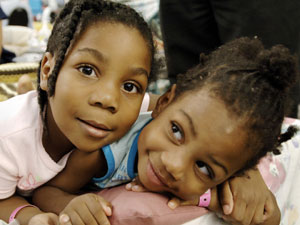 
Hurricane Katrina evacuee Nale Jackson (L) and her sister Jai'Lynn Butler (R) lie on their bed on the floor of the Astrodome in Houston, Texas.  (STAN HONDA/AFP/Getty Images)