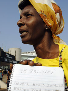 
 Hurricane Katrina evacuee Sandra Nelson holds up information about where her son Walter has been sent with Nelson's sister to a shelter in Oklahoma, 06 September, 2005, outside the Astrodome in Houston, Texas. Nelson was looking for transportation to Oklahoma to find her son.  (STAN HONDA/AFP/Getty Images)