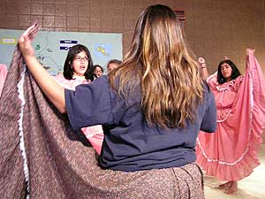 
A former camper teaches high school girls how to dance the Cumbia at La Semana, a cultural camp for kids adopted from Latin America. (MPR Photo/Bianca Vazquez Toness)