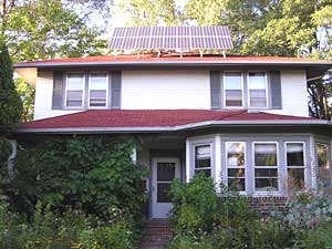 
David Boyce has solar electric panels on his house. He spent $20,000 for them in 1998. But he says people who are interested in solar thermal heat can install a system for much less money.  (MPR Photo/Lorna Benson)