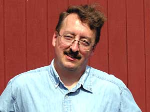 
Chris Born is happy with his solar electrical system, but says he wishes he had installed solar thermal heat at the same time. (MPR Photo/Lorna Benson)