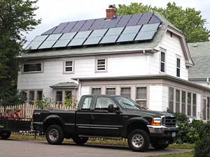 
Christine Ziebold and John Carpenter have eight solar thermal heating panels on the lower edge of their roof. They also have 12 solar electric panels lining the top edge of the roof. (MPR Photo/Lorna Benson)