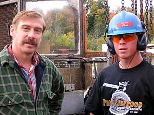 
Kent Price, left, founded Price Firewood in Cloquet 20 years ago.  His son, Kent Price Jr., right, is helping out during the busy fall firewood season. (MPR Photo/Bob Kelleher)