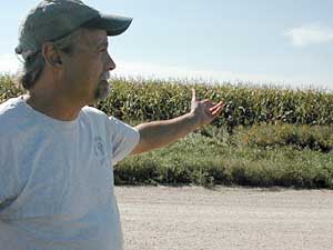 
Paul Woltzka points to fields of corn, soybeans and other row crops that are planted in the Whitewater River watershed. He says the herbicide atrazine, which is used extensively on such crops, is running off into the river. (MPR Photo/Dan Olson)