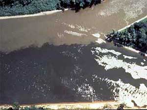 
The confluence of the Minnesota and Mississippi Rivers. This photo illustrates the pollution and sediment that is contained in the Minnesota, and dumped here into the Mississippi. The Minnesota has been called the state's dirtiest river.  (Photo courtesy of the MPCA)