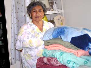 
Josephine Ruiz relies on this stack of blankets to keep warm in the winter. (MPR Photo/Lorna Benson)