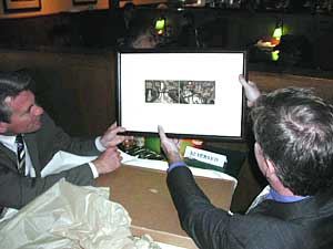 
Rybak presented Coleman with a painting by Twin Cities artist James Boyd-Brent, which depicts Mississippi River scenes in both downtowns.  (MPR Photo/William Wilcoxen)