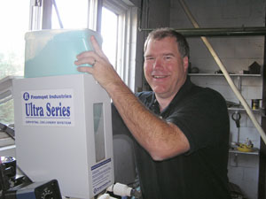 
Rob Herbon sells this dehydrated powder, which is used to clean corrosion from boiler water. Herbon's company thinks it can ship the product to China cheaply because it weighs so much less than a standard 55-gallon drum of cleaning chemicals.  (MPR Photo/Lorna Benson)