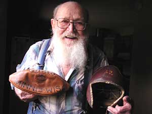 
Bob Weld went from Washburn High School in Minneapolis to the University of Minnesota football team. He's holding his U of M football helmet, and a football from his last game. It was against Wisconsin in 1937.  Minnesota won. (MPR Photo/Mark Steil)