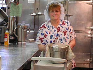 
Sharon McKeever takes a pot of soup off the stove in the kitchen at St. Luke's Hospital in Duluth.  Food managers are adding hormone-free milk and organic fruits and vegetables to the menu.   (MPR photo/Stephanie Hemphill)