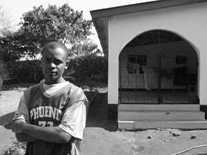
Emanueli John stands outside the entrance to the residence of James Assey, the home base for Eller-Isaacs research in Tanzania. (Photo: Jonah Eller-Isaacs)