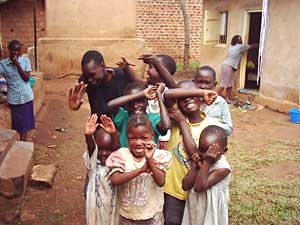 
Children in Kalerwe pretend to try and avoid having their picture taken. (Photo: Jonah Eller-Isaacs)