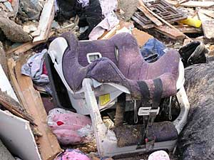 
Piles of wood and trash are all that's left of a meth house in Sacred Heart after local officials knocked it down.  Among the piles of debris were clothes, furniture and this child's car seat.  (MPR Photo/Tim Post)