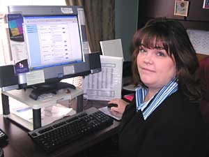 
Wendy Traffie scans her computer records every morning to check on the movements of the seniors in the Lakewood Commons assisted living center. If they spend too much time in one room, Traffie checks in on them to make sure they're okay. (MPR Photo/Lorna Benson)