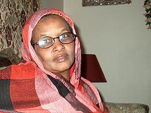 
Biyod Shakia sits in Anab Garuf’s flowerfilled apartment. She has lived in Rochester for the past 11 years. She has nine children, and sent one back to Somalia to keep him from using or selling drugs.  (MPR photo/Sea Stachura)