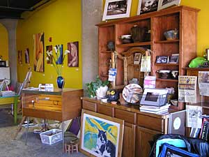 
The large gallery is in an old warehouse near Sioux Falls'  railroad district, just on the edge of downtown. It will offer room for about 25 artists to show their work. It's a working studio now, messy but interesting.  There's a wild Jackson Pollack kind of floor with drizzled paint in all colors.  The walls are a brilliant gold. (MPR Photo/Cara Hetland)