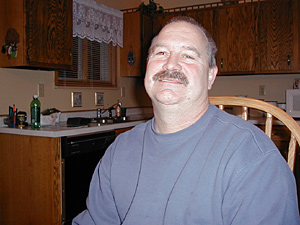 
Tom Perkins, a baggage handler and 25-year veteran of Northwest, has helped organize a referral list of side businesses run by Northwest employees. (MPR Photo/Jeff Horwich)