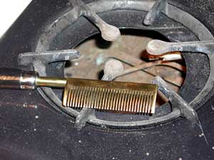 
A hot comb on a stove. Many black women and girls have been subjected to the hot comb treatment to straighten their hair. (MPR photo/Chris Roberts)