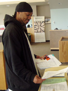 
Tierre Caldwell, a forestry worker with the city of Minneapolis, checks out information at a health fair.  (MPR Photo/Annie Baxter)
