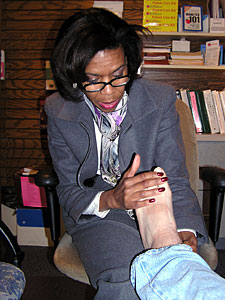 
Pharmacist Brenda Strawn examines John Parkos' feet during his monthly visit. Frequent check-ups and reminders about how to take care of himself help Parkos manage his diabetes.

 (MPR Photo/Stephanie Hemphill)