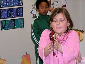 
This second grader is playing with a Chinese musical instrument, part of the exhibit "French Fries to Wontons: A Journey of 6,000 Miles."
 (MPR Photo/Bob Reha)
