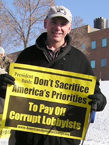 
Dale Howey of Roseville says he tries to mark every Bush visit to Minnesota by protesting outside. (MPR Photo/Laura McCallum)