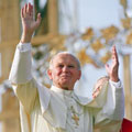 Pope John Paul II waves to a cheering crowd during a 1987 visit to Poland. (Eric Feferberg/AFP/Getty Images)